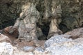 Surfaced rock that over the centuries became a cavernous cliff with a small stony beach in front, Palinuro, Italy. Royalty Free Stock Photo